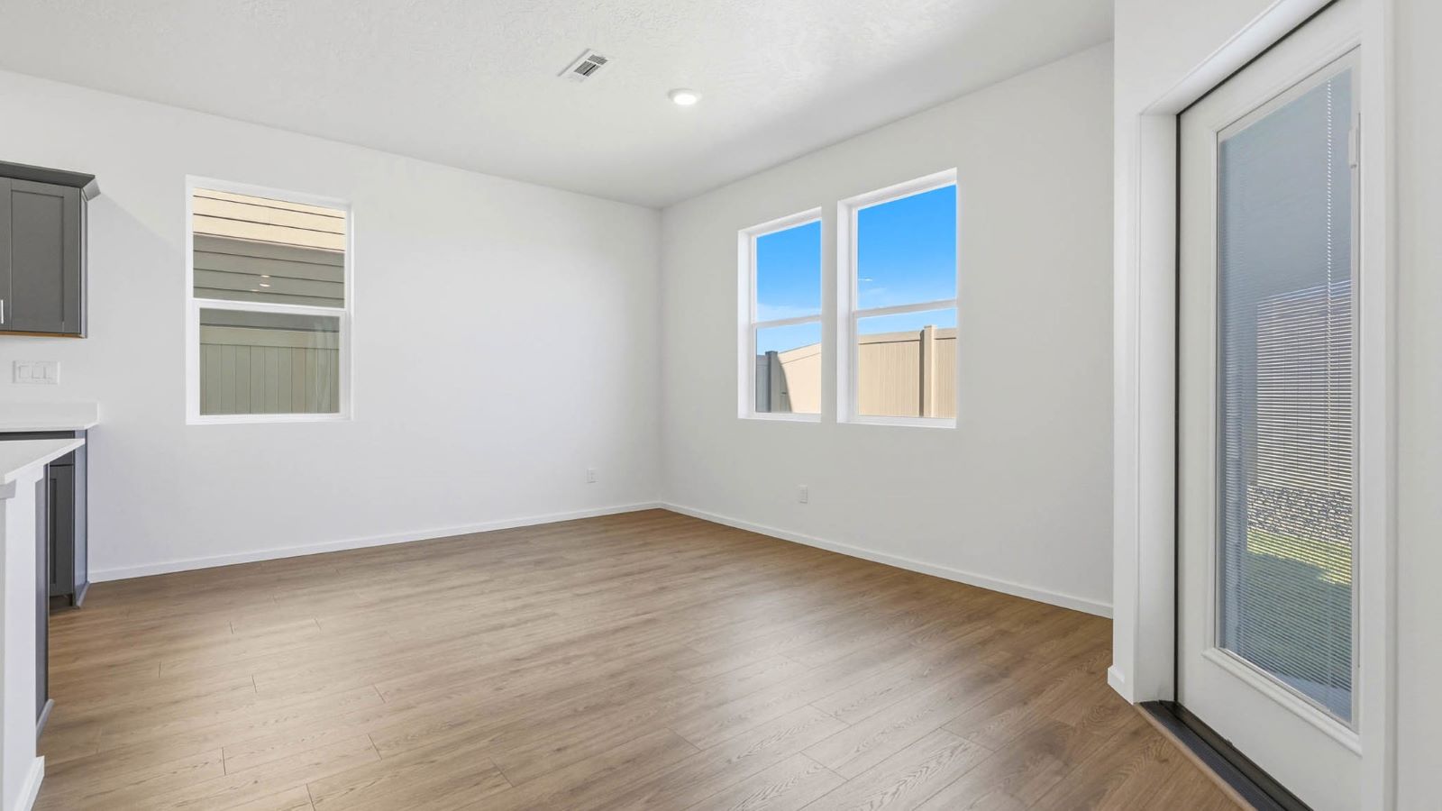 Dining area with a sliding glass door to a fenced backyard