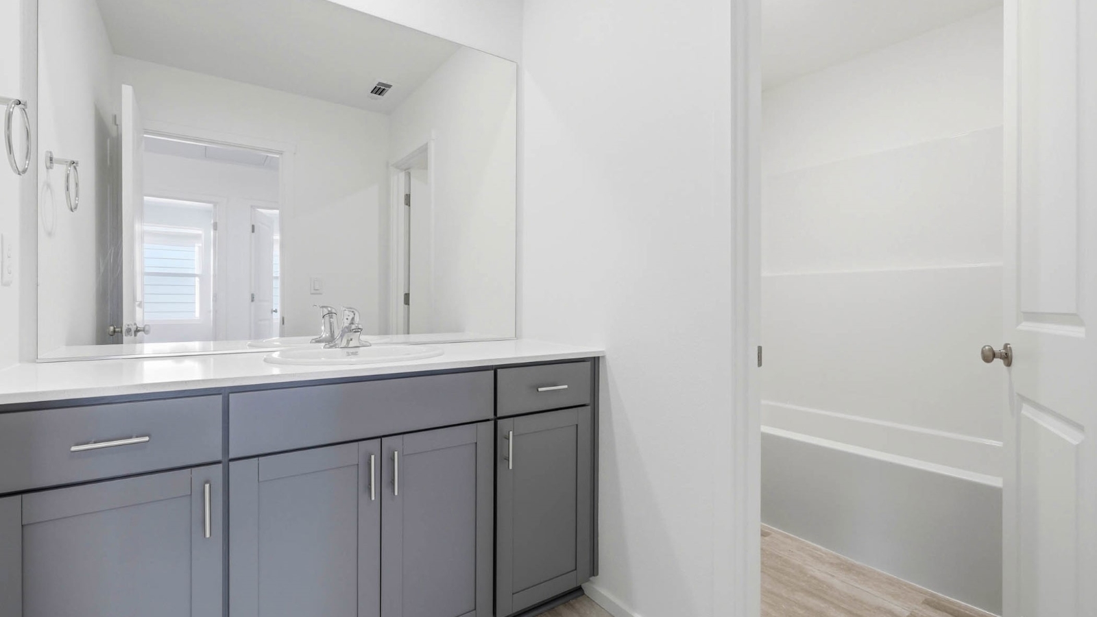 Hall bathroom with combination tub/shower and quartz counters