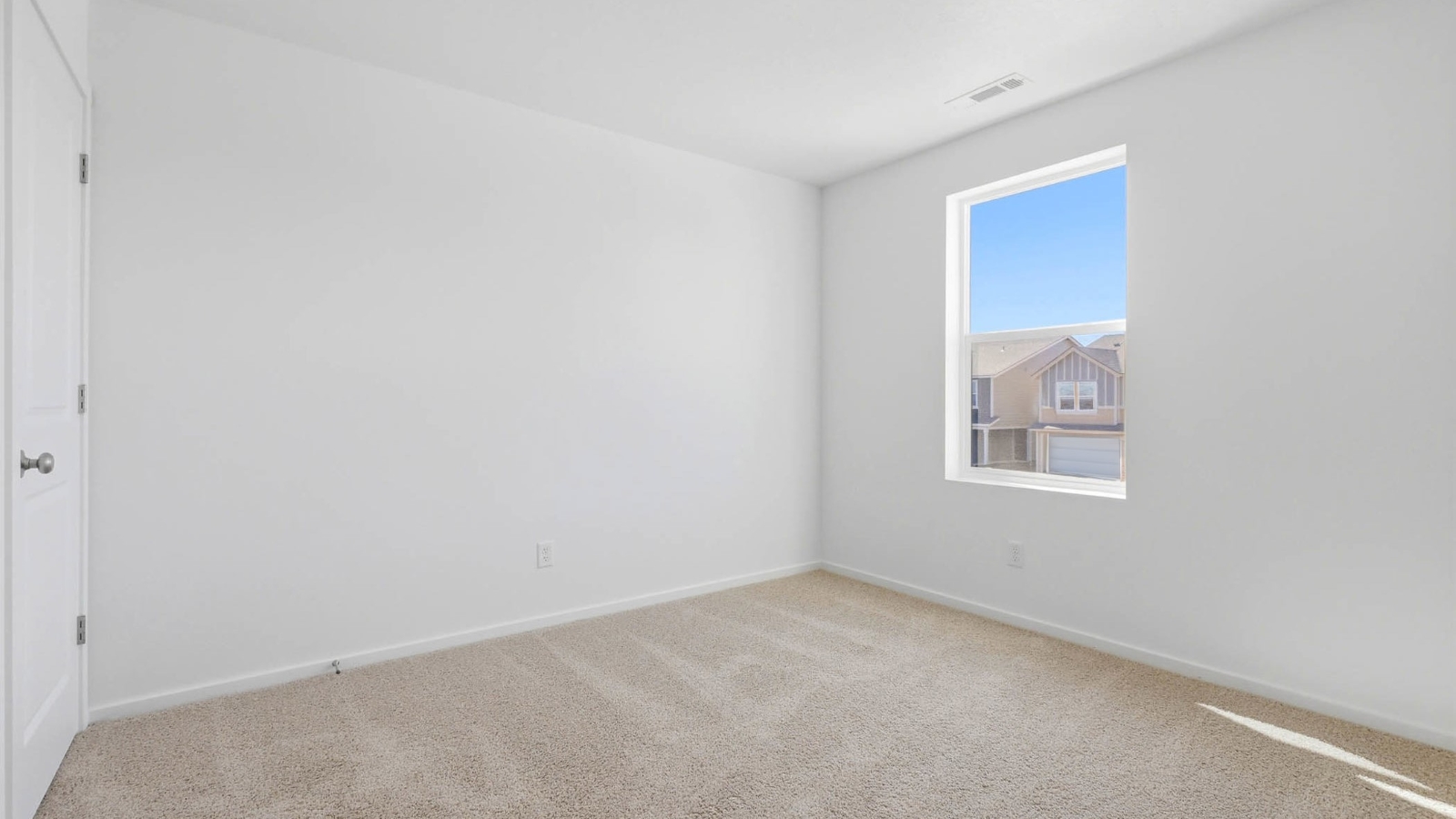 Bedroom with wall-to-wall carpet and a closet