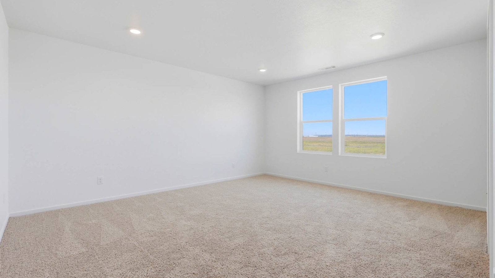 Primary bedroom with wall-to-wall carpet, a walk-in closet and an attached bathroom