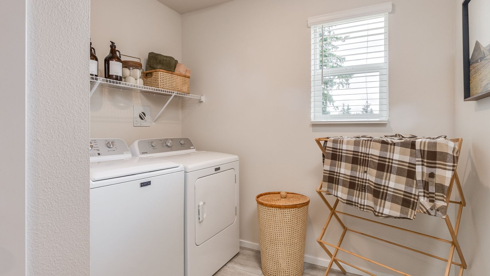 Laundry room with built-in shelves and washer and dryer hookups