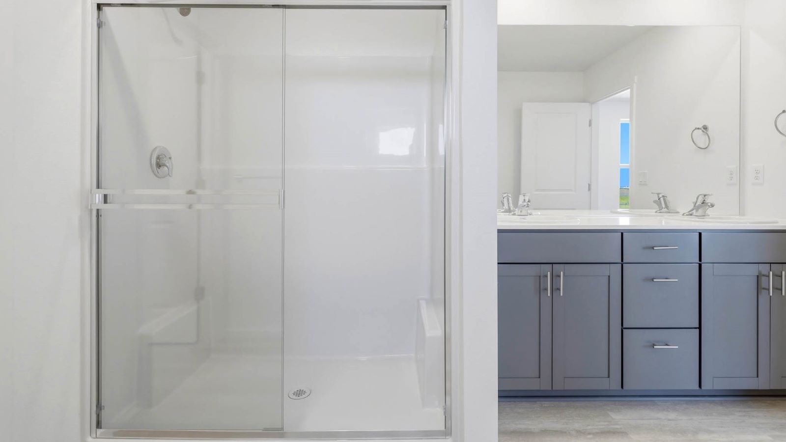 Primary bathroom with quartz counters and a walk-in shower