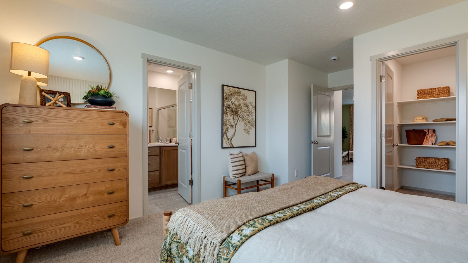 Primary bedroom with wall-to-wall carpet, a walk-in closet and an attached bathroom
