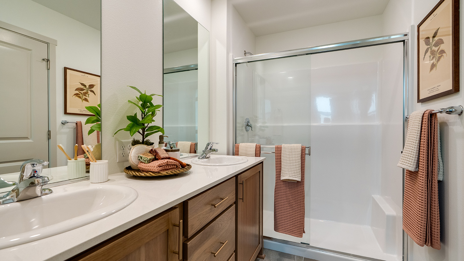 Primary bathroom with quartz counters and a walk-in shower
