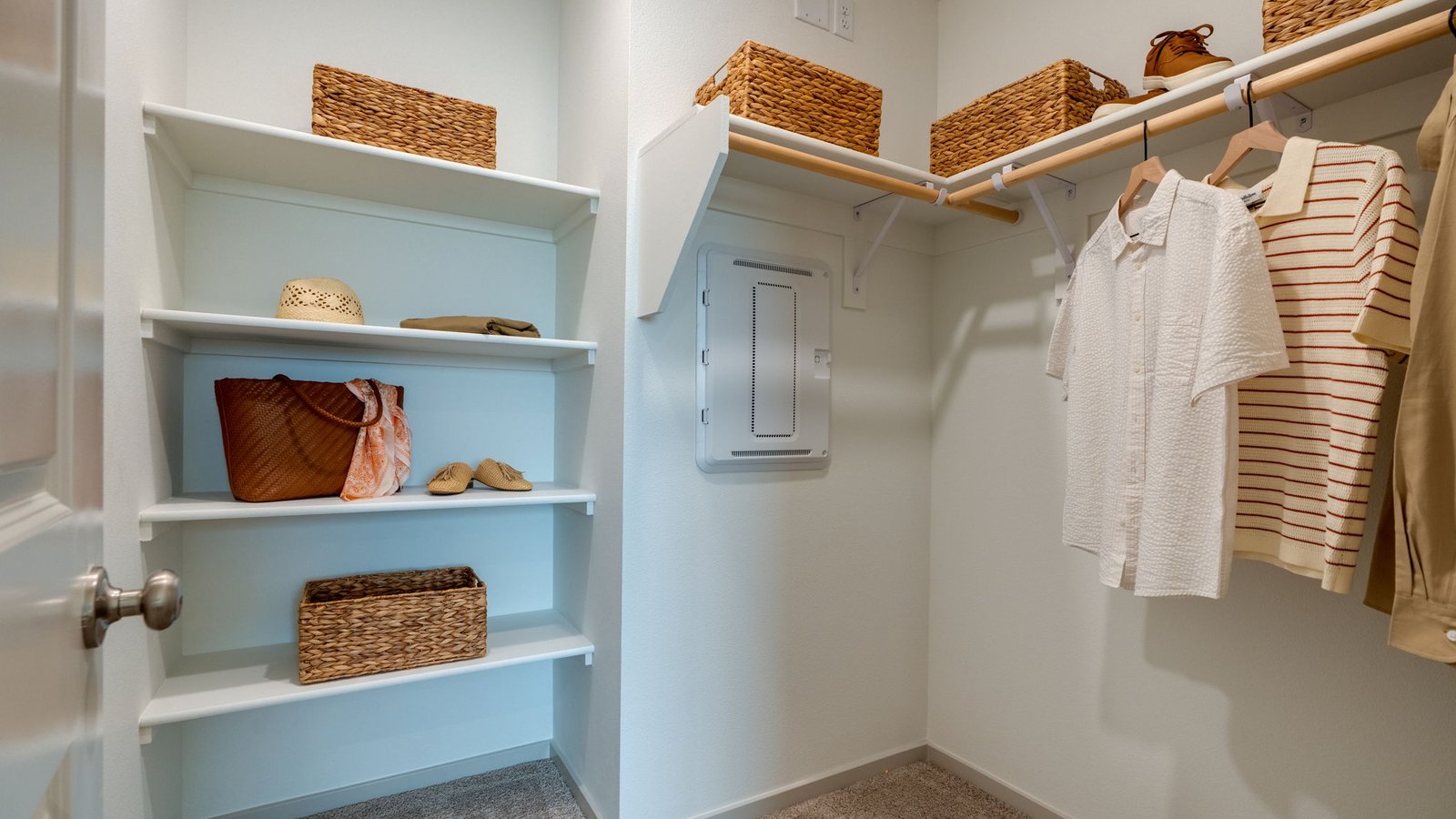 Primary bedroom walk-in closet with built-in shelves