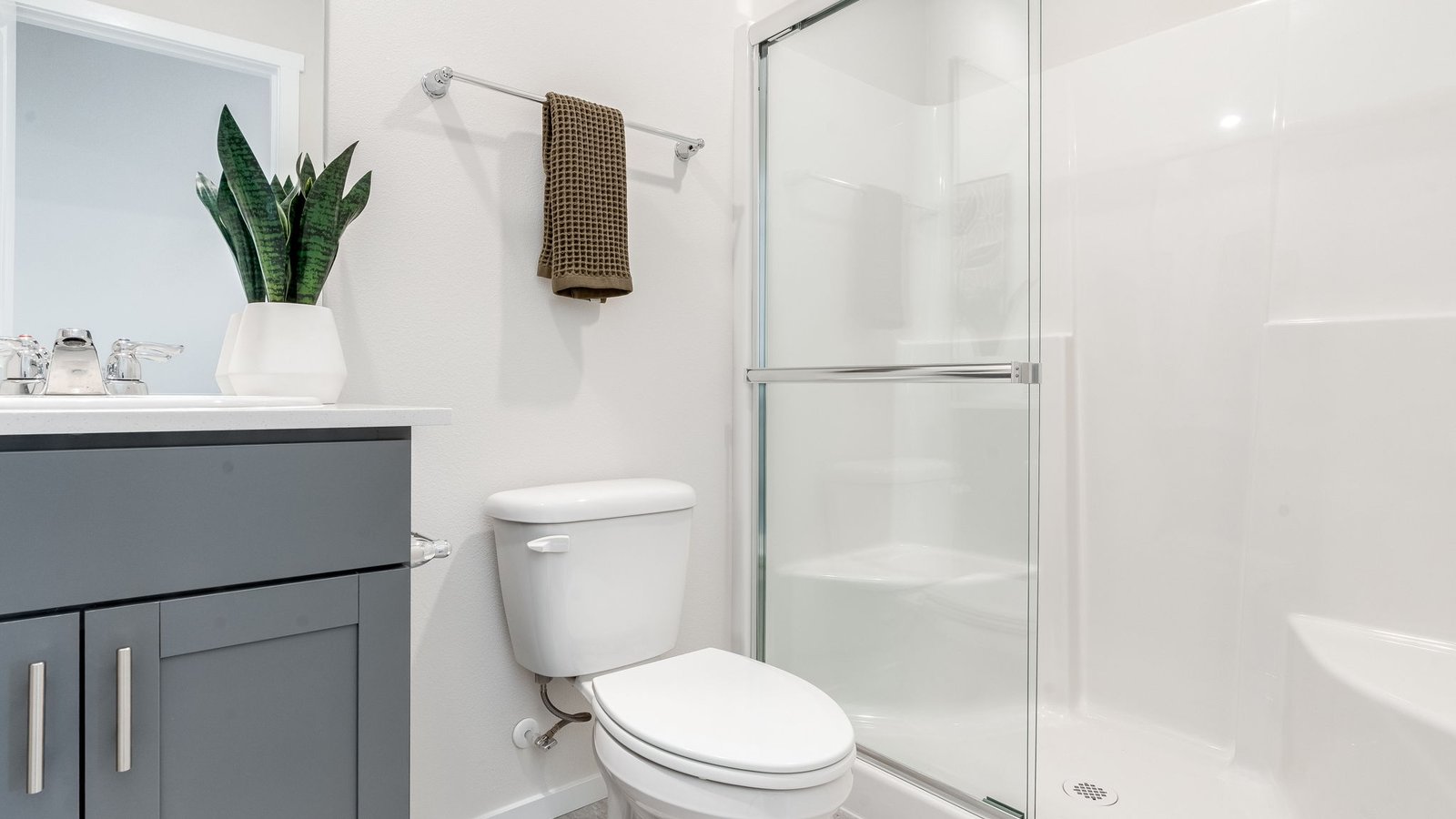 bathroom with quartz counters and a walk-in shower