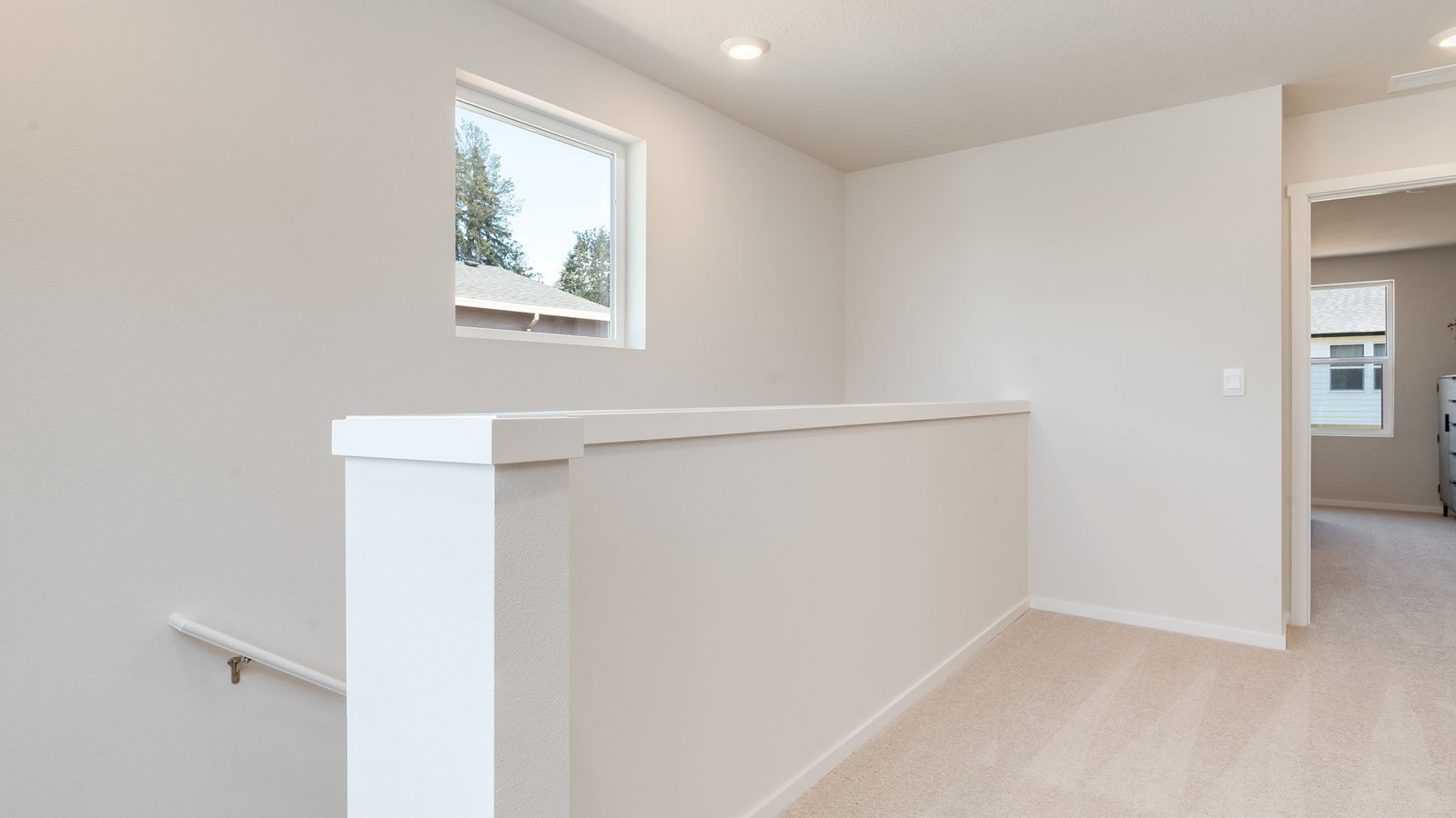 Hallway with wall-to-wall carpet