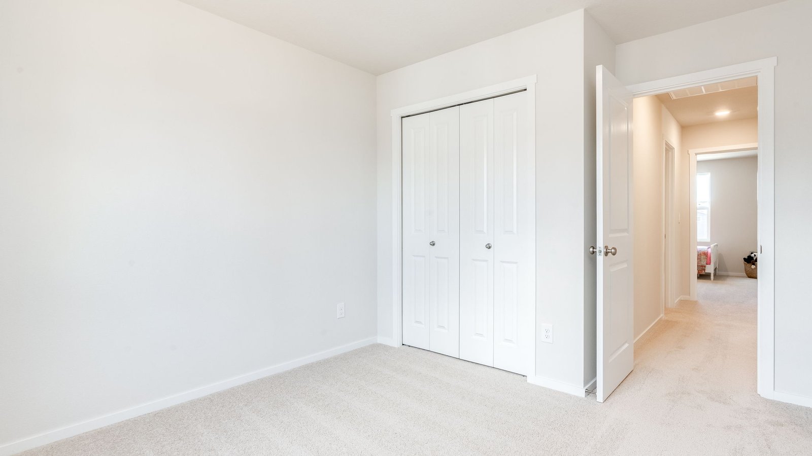 Bedroom with wall-to-wall carpet and a closet