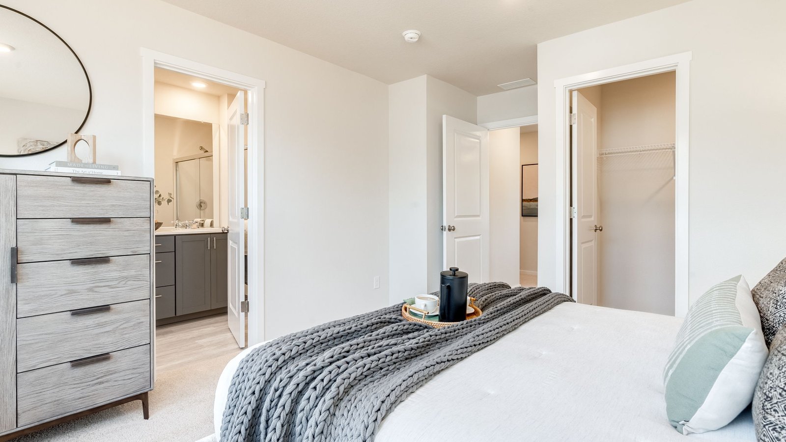 Primary bedroom with wall-to-wall carpet, a walk-in closet and an attached bathroom