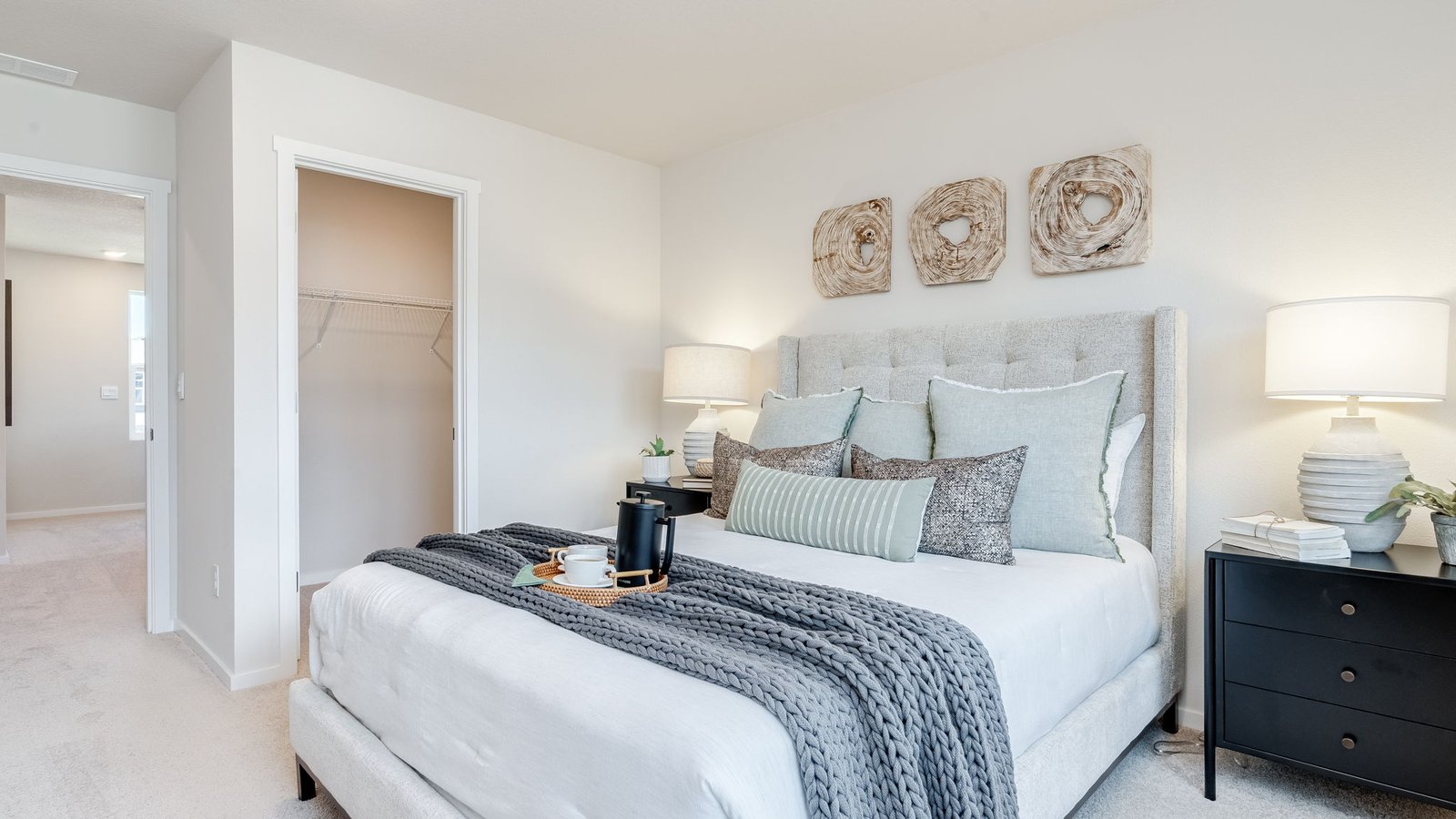 Primary bedroom with wall-to-wall carpet, a walk-in closet and an attached bathroom
