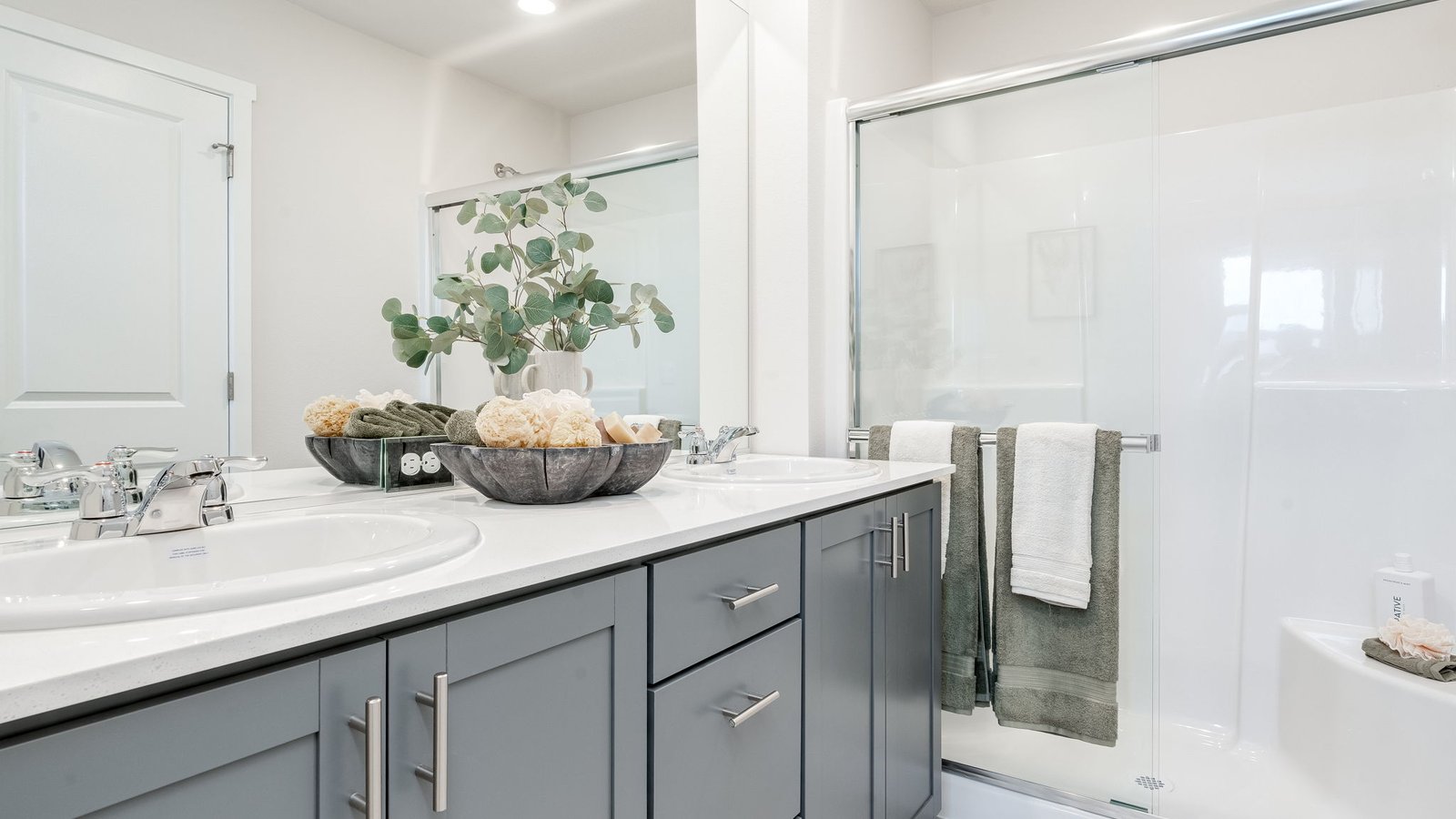Primary bathroom with quartz counters and a walk-in shower