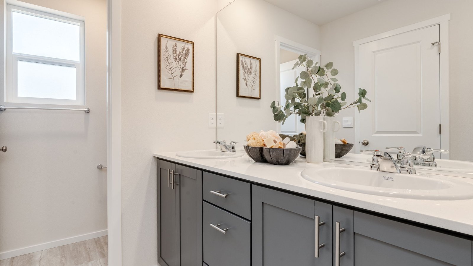 Primary bathroom with quartz counters and a walk-in shower