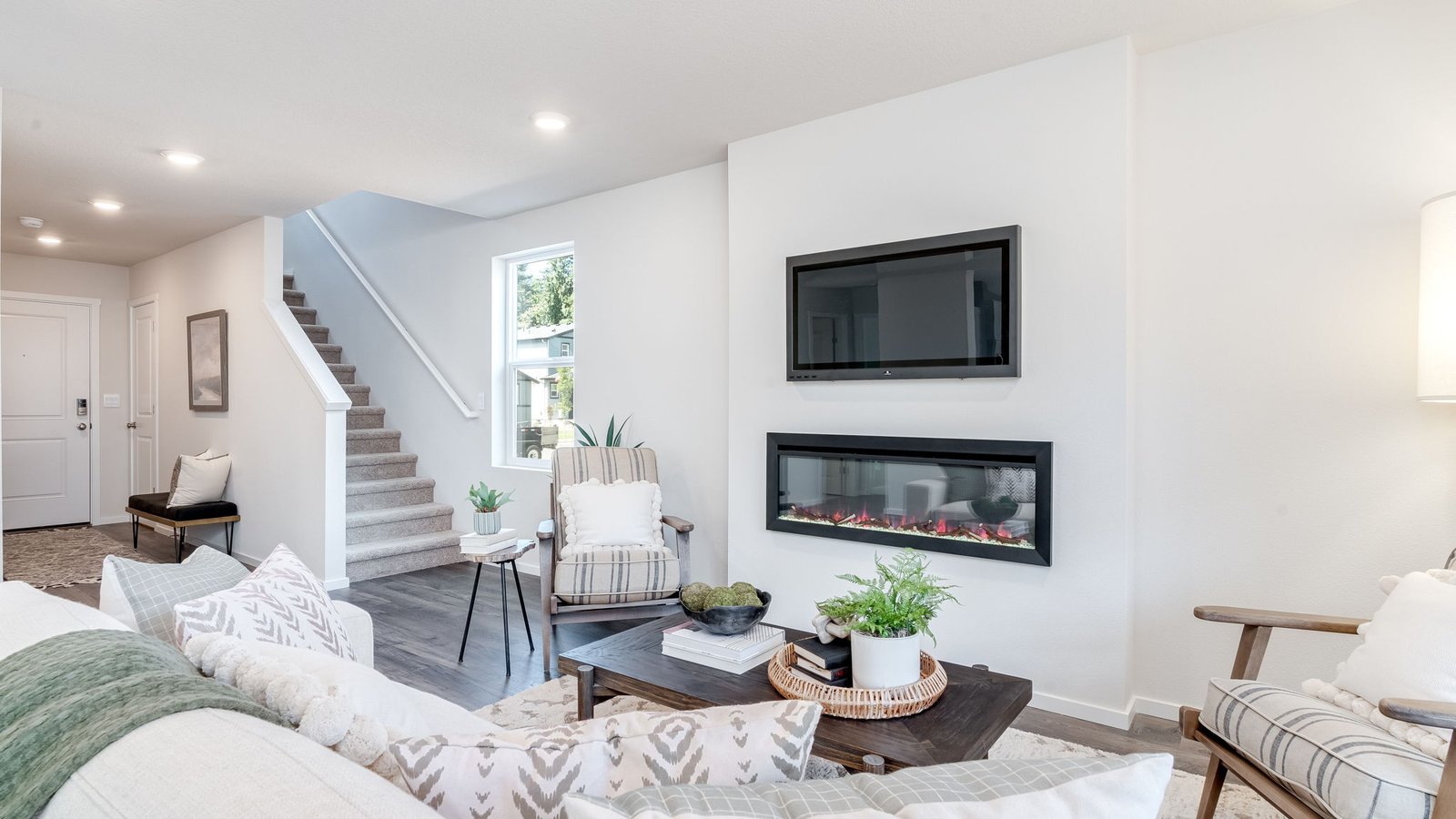 Great room with laminate flooring and an electric fireplace