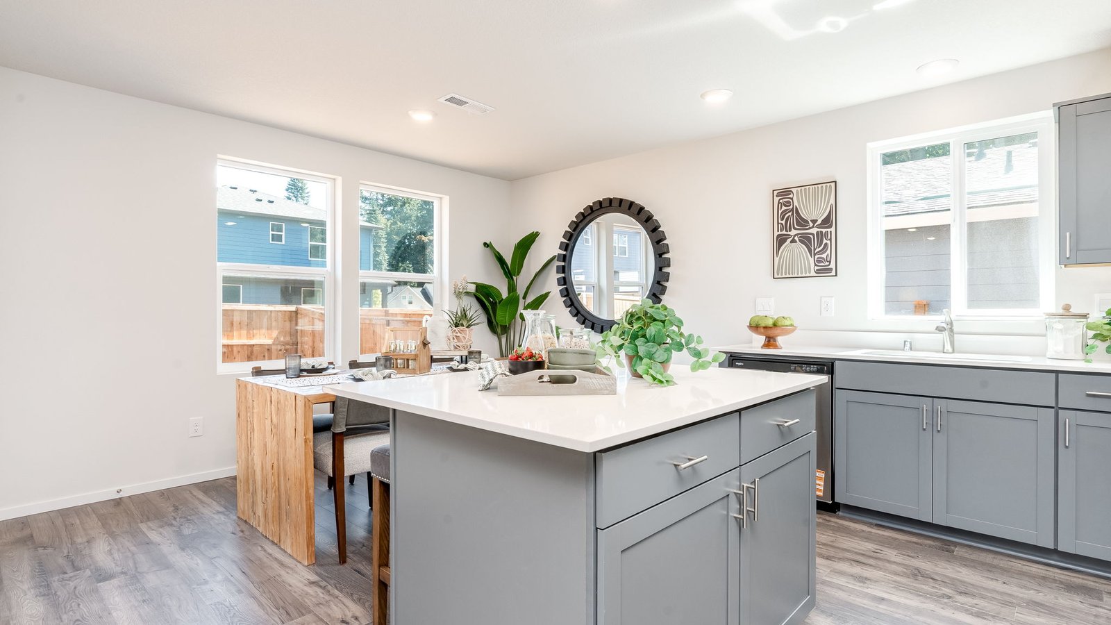 Kitchen with shaker cabinets, quartz counters, stainless steel appliances, pantry, and an island with a breakfast bar