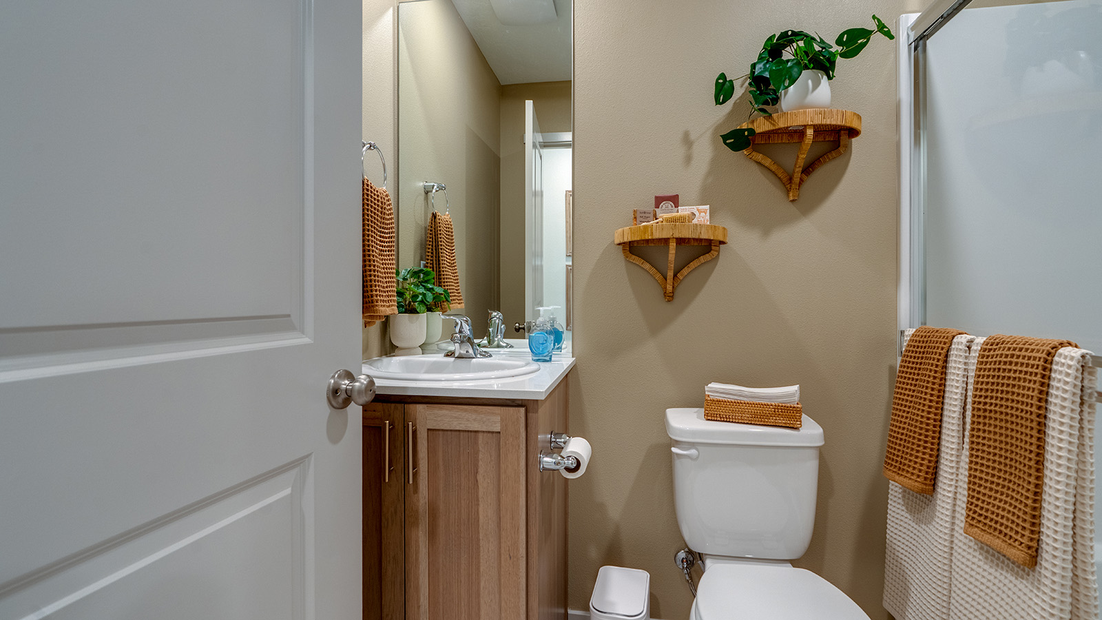 bathroom with quartz counters and a walk-in shower