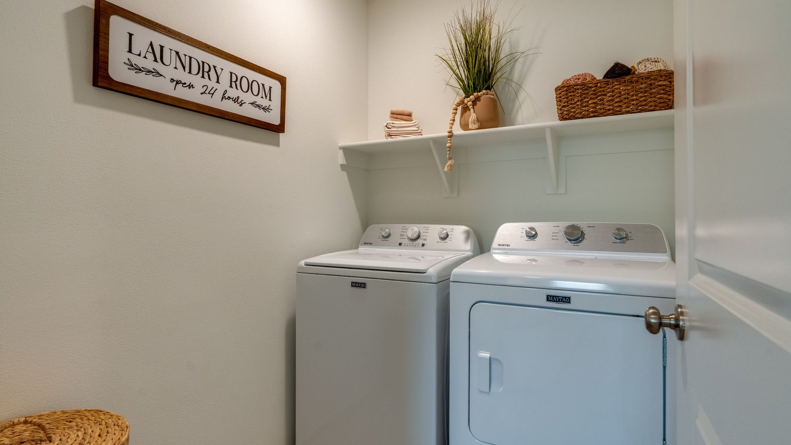 Laundry room with wire shelves and washer and dryer hookups