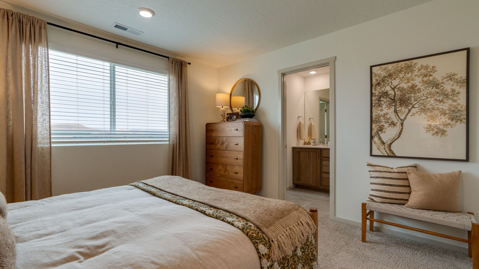 Primary bedroom with wall-to-wall carpet, a walk-in closet and an attached bathroom