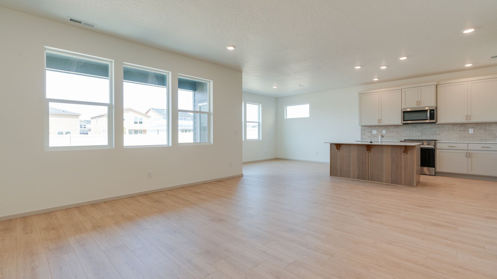 Great room with laminate flooring and an electric fireplace