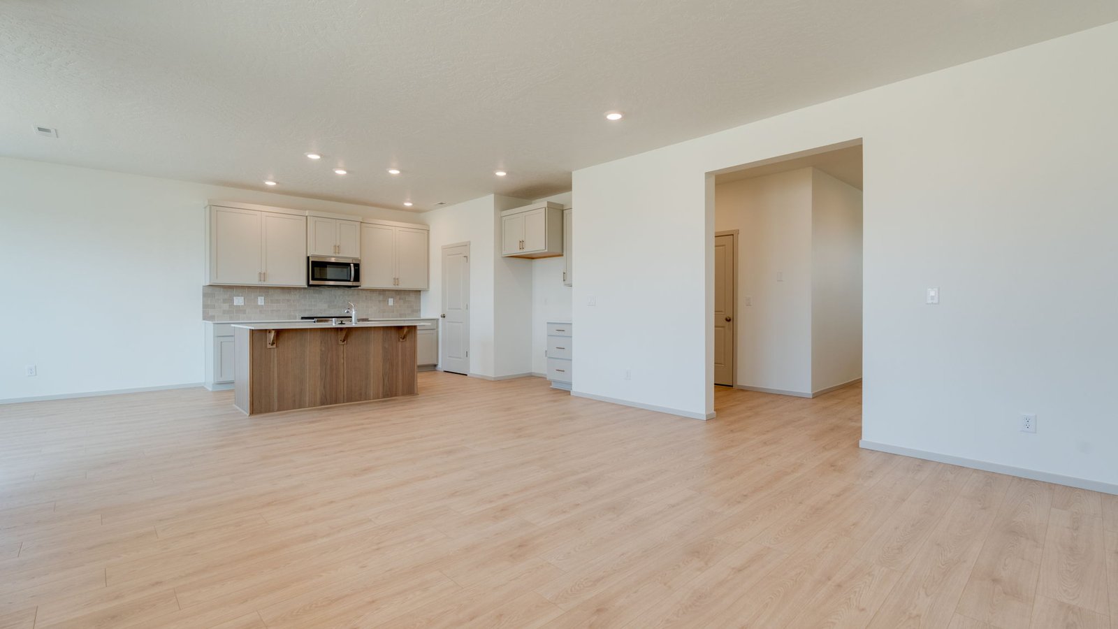 Great room with laminate flooring and an electric fireplace
