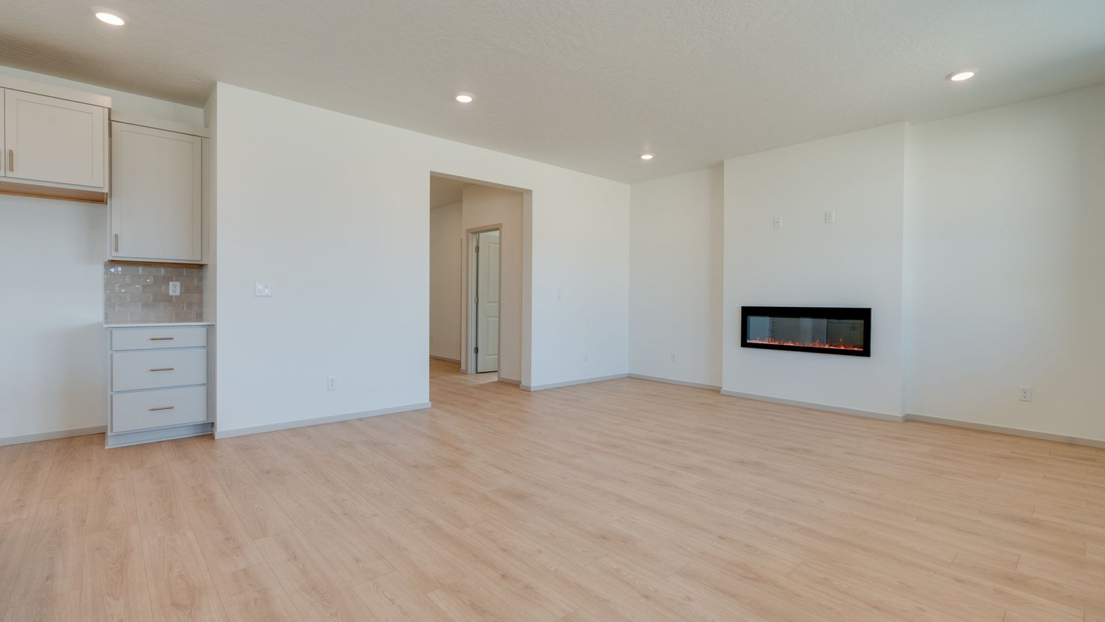 Great room with laminate flooring and an electric fireplace