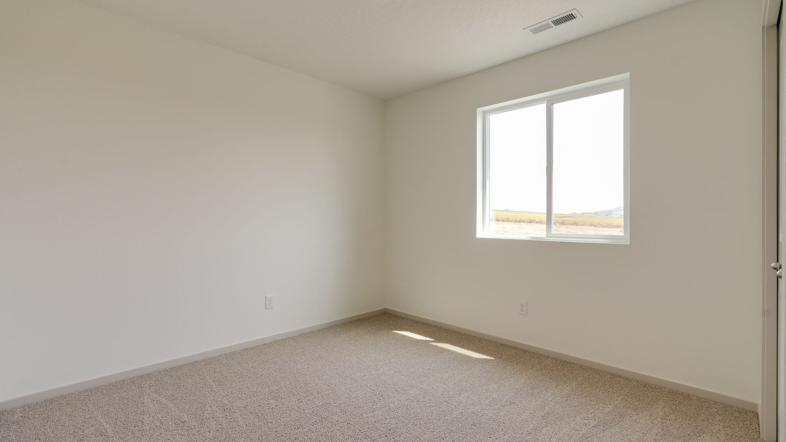 Bedroom with wall-to-wall carpet and a closet