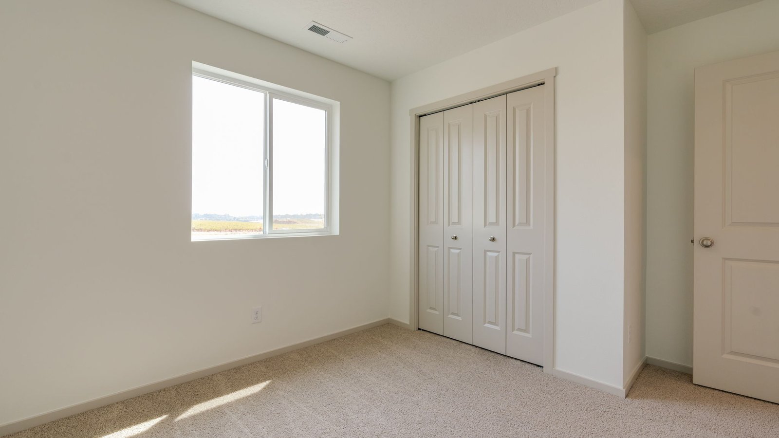 Bedroom with wall-to-wall carpet and a closet