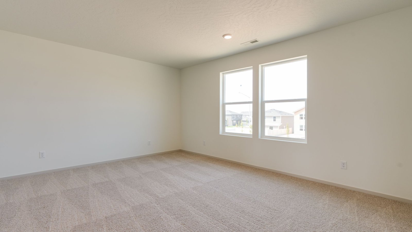 Primary bedroom with wall-to-wall carpet, a walk-in closet and an attached bathroom