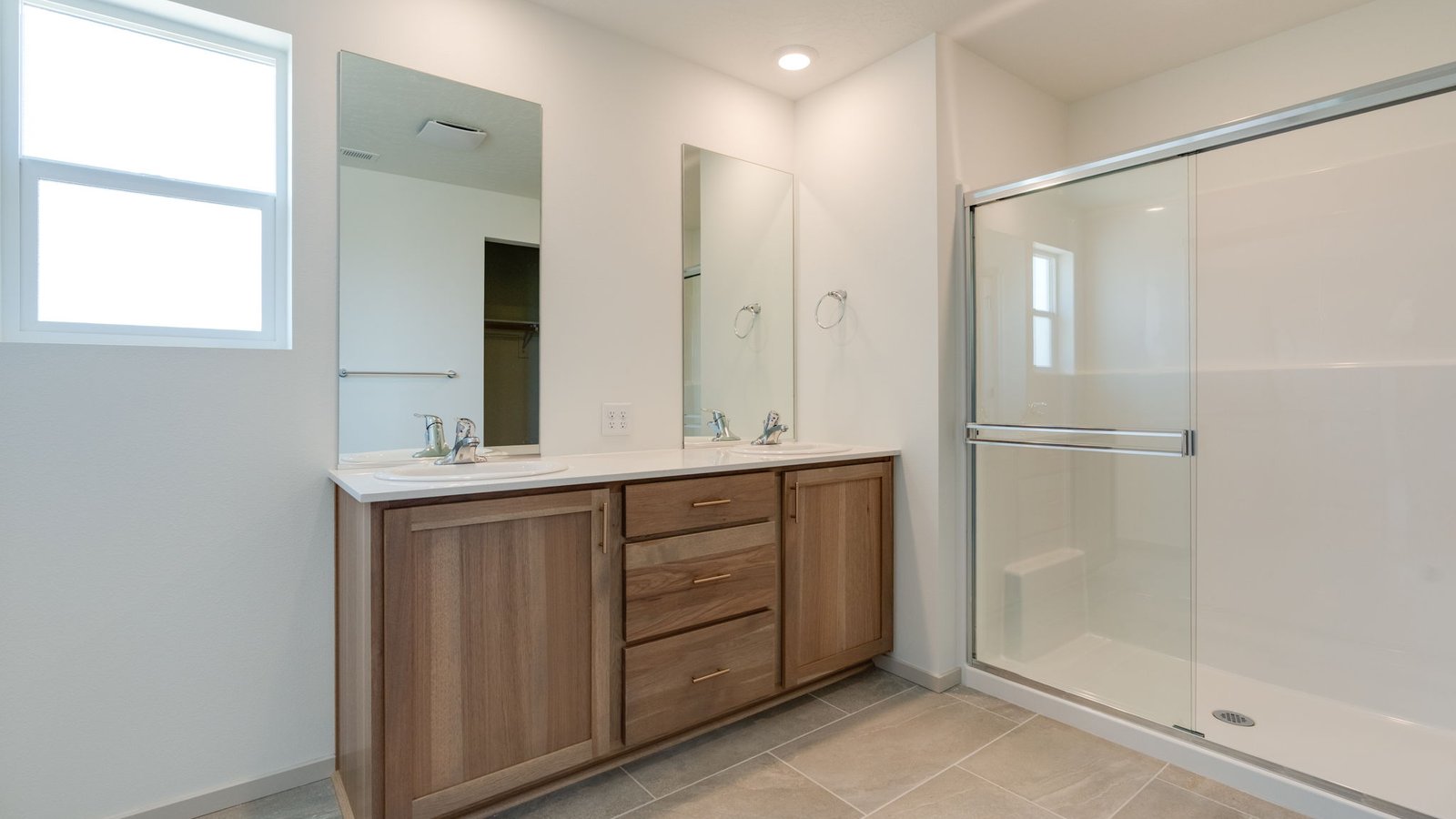 Primary bathroom with quartz counters and a walk-in shower