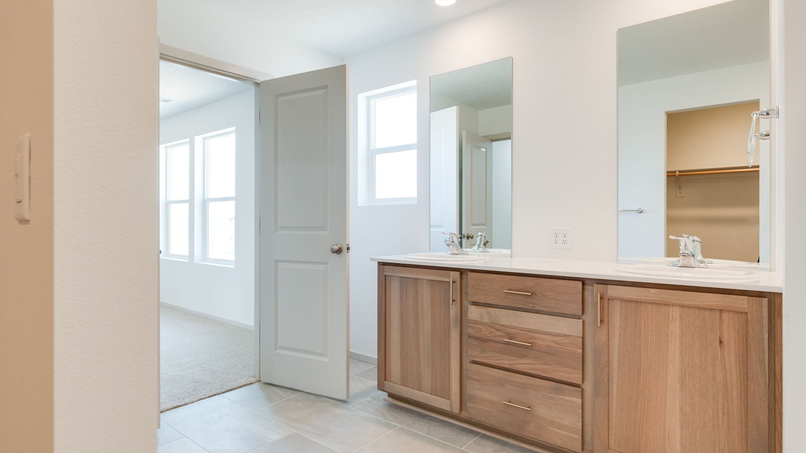 Primary bathroom with quartz counters and a walk-in shower