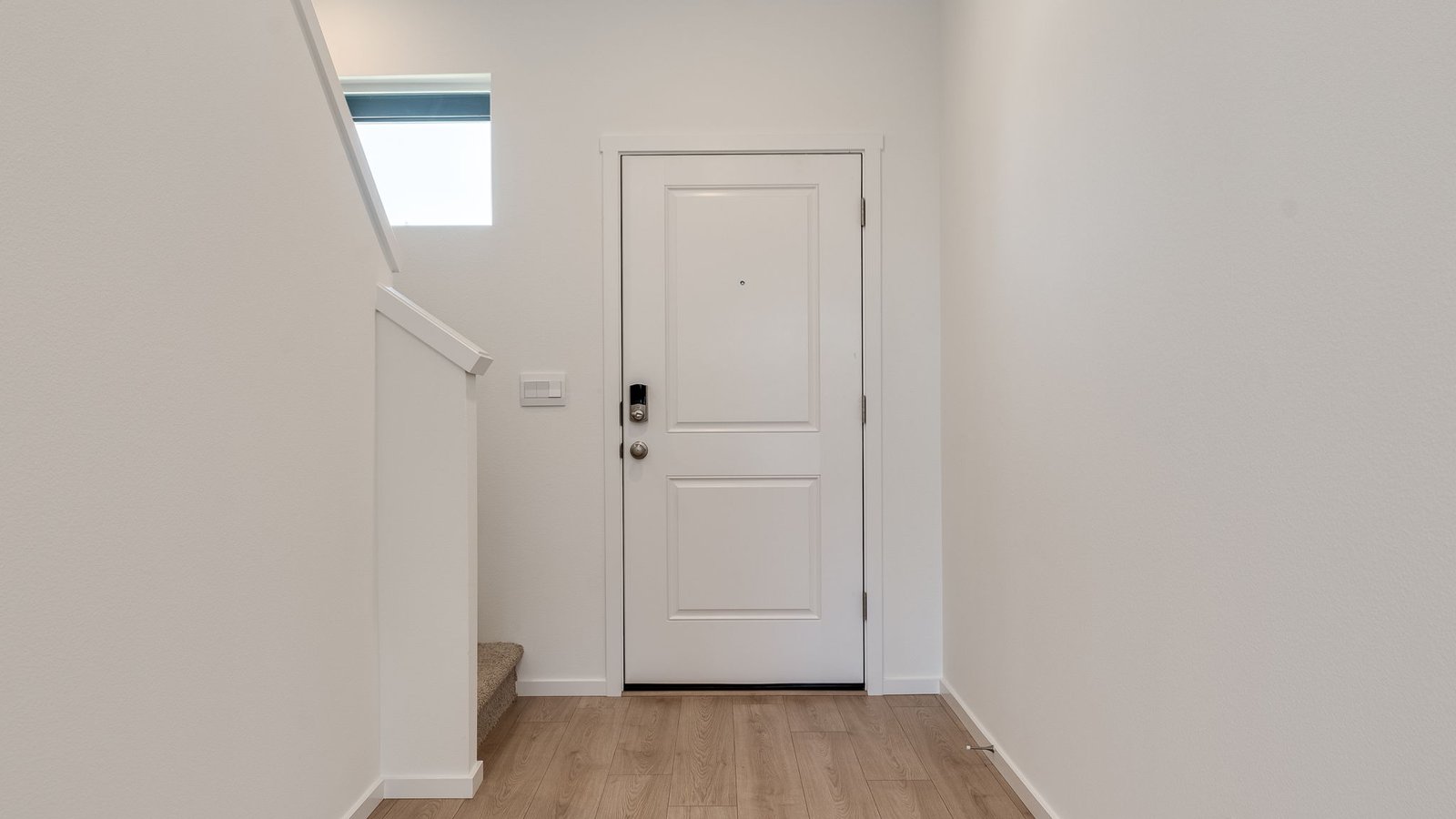 Entryway with a coat closet and laminate flooring