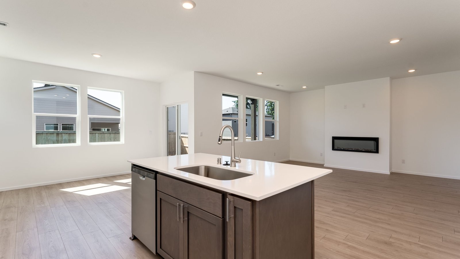 Kitchen with shaker cabinets, quartz counters, stainless steel appliances, pantry, and an island with a breakfast bar