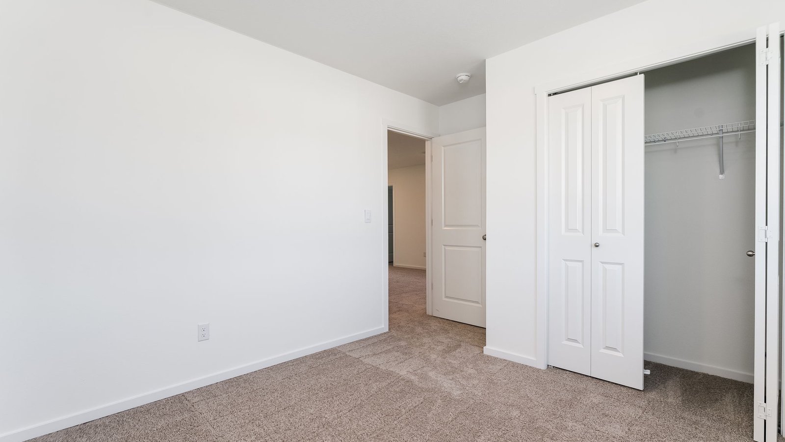 Bedroom with wall-to-wall carpet and a closet