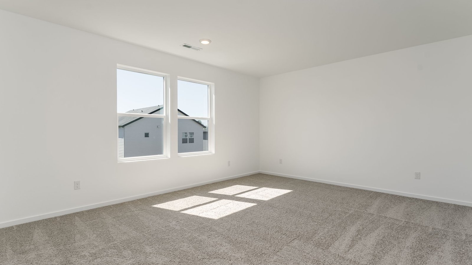 Primary bedroom with wall-to-wall carpet, a walk-in closet and an attached bathroom
