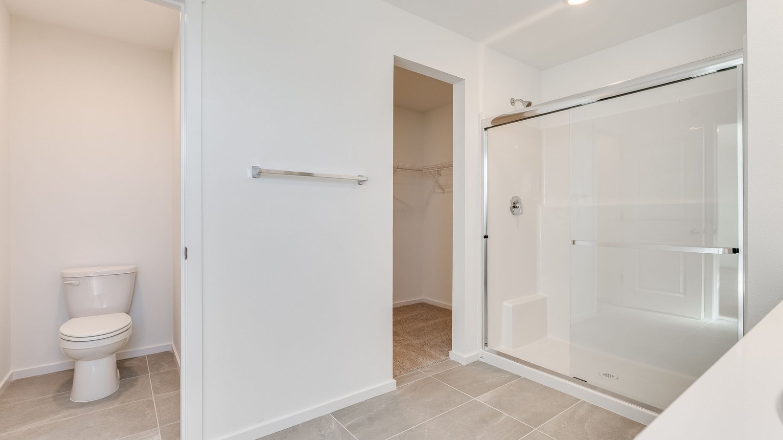 Primary bathroom with quartz counters and a walk-in shower