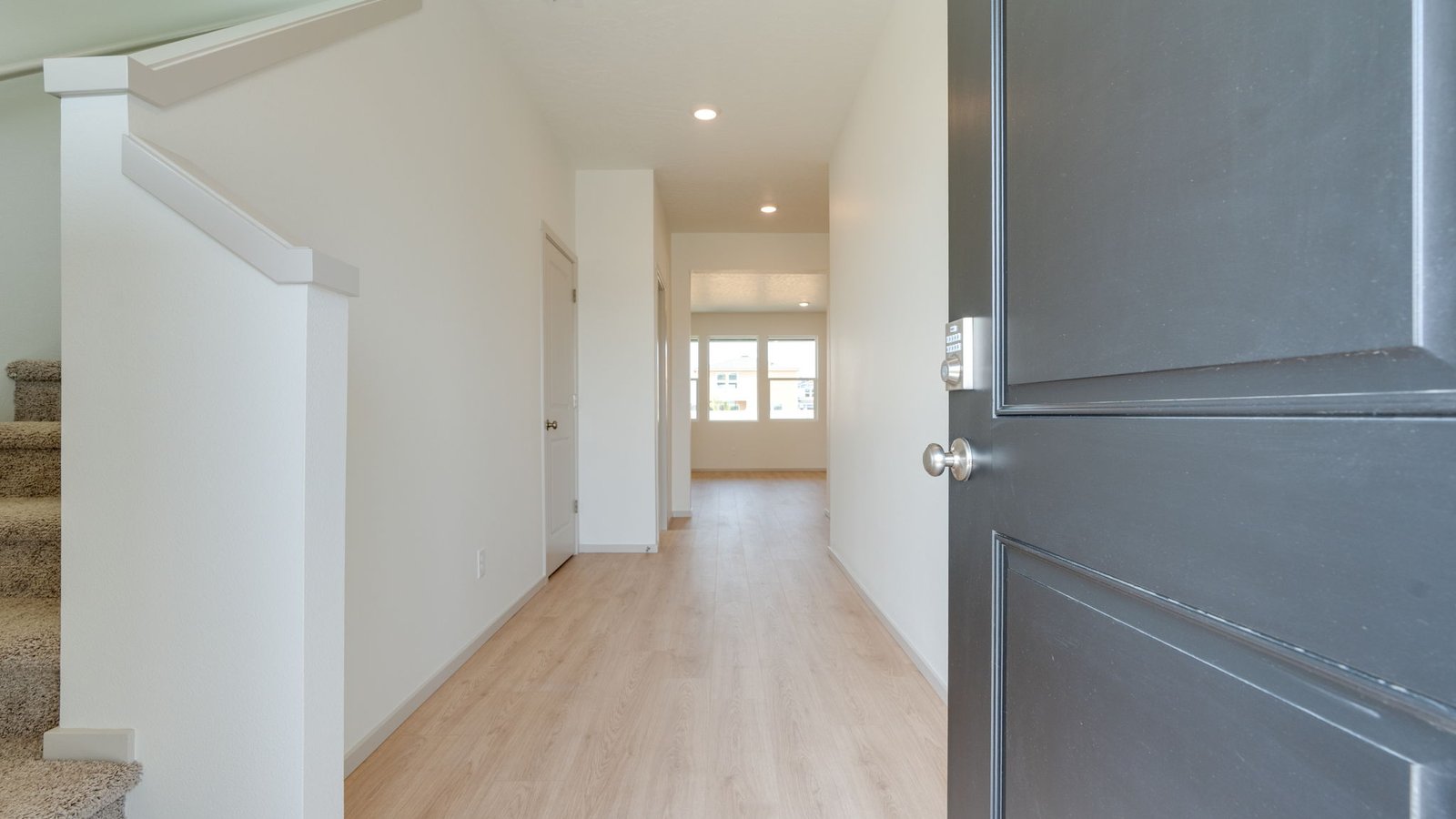 Entryway with a coat closet and laminate flooring