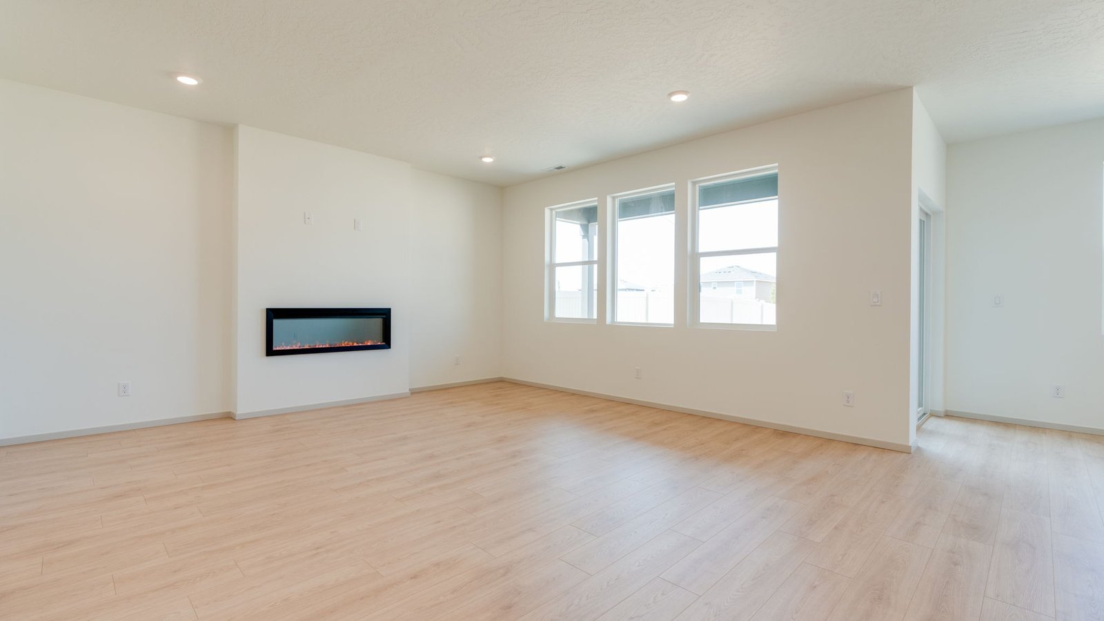 Great room with laminate flooring and an electric fireplace