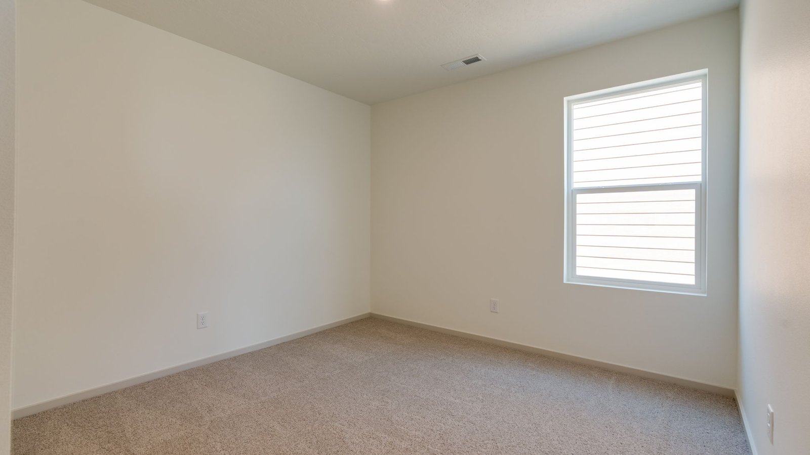 Bedroom with wall-to-wall carpet and a closet