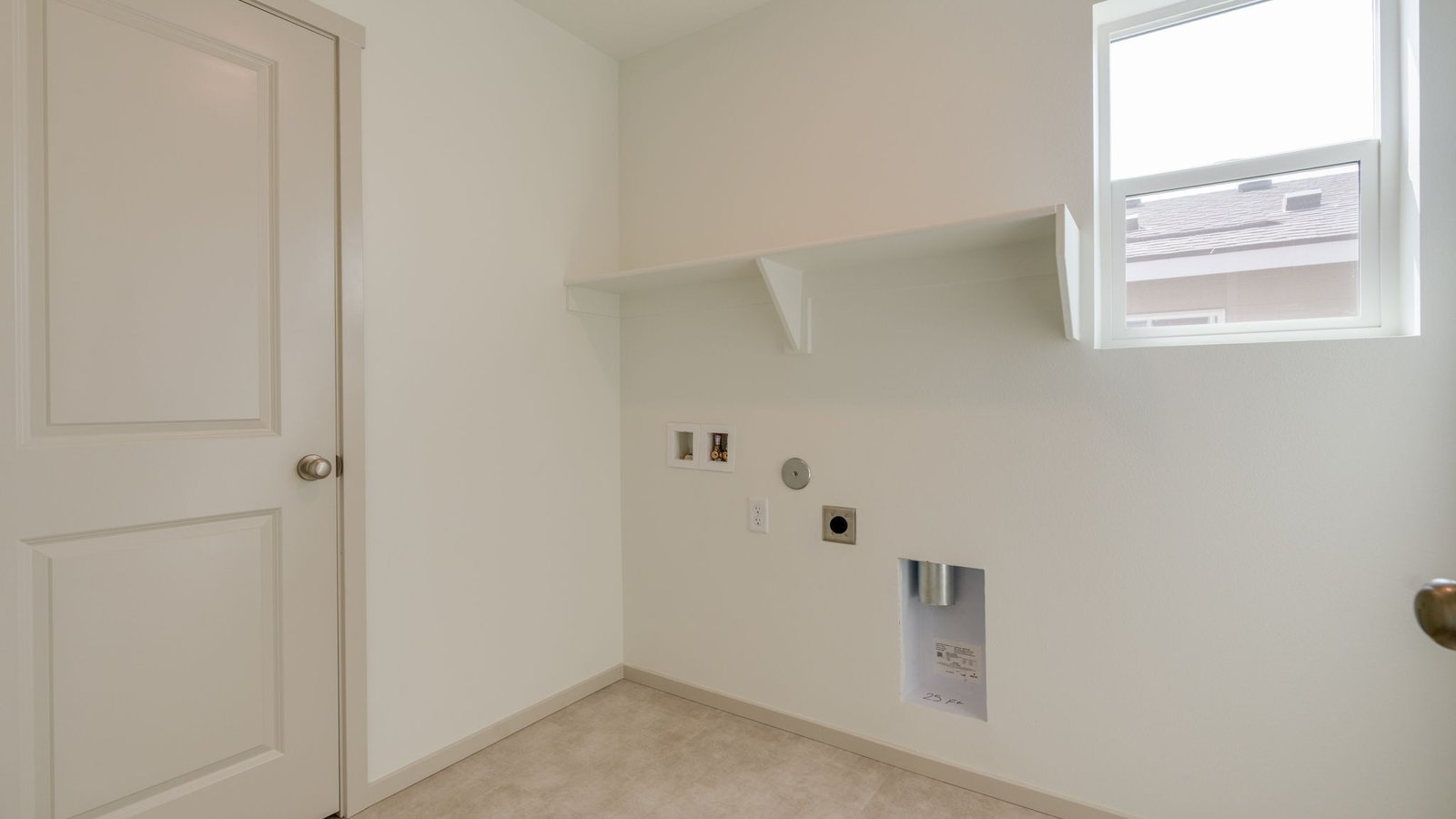 Laundry room with built-in shelves and washer and dryer hookups