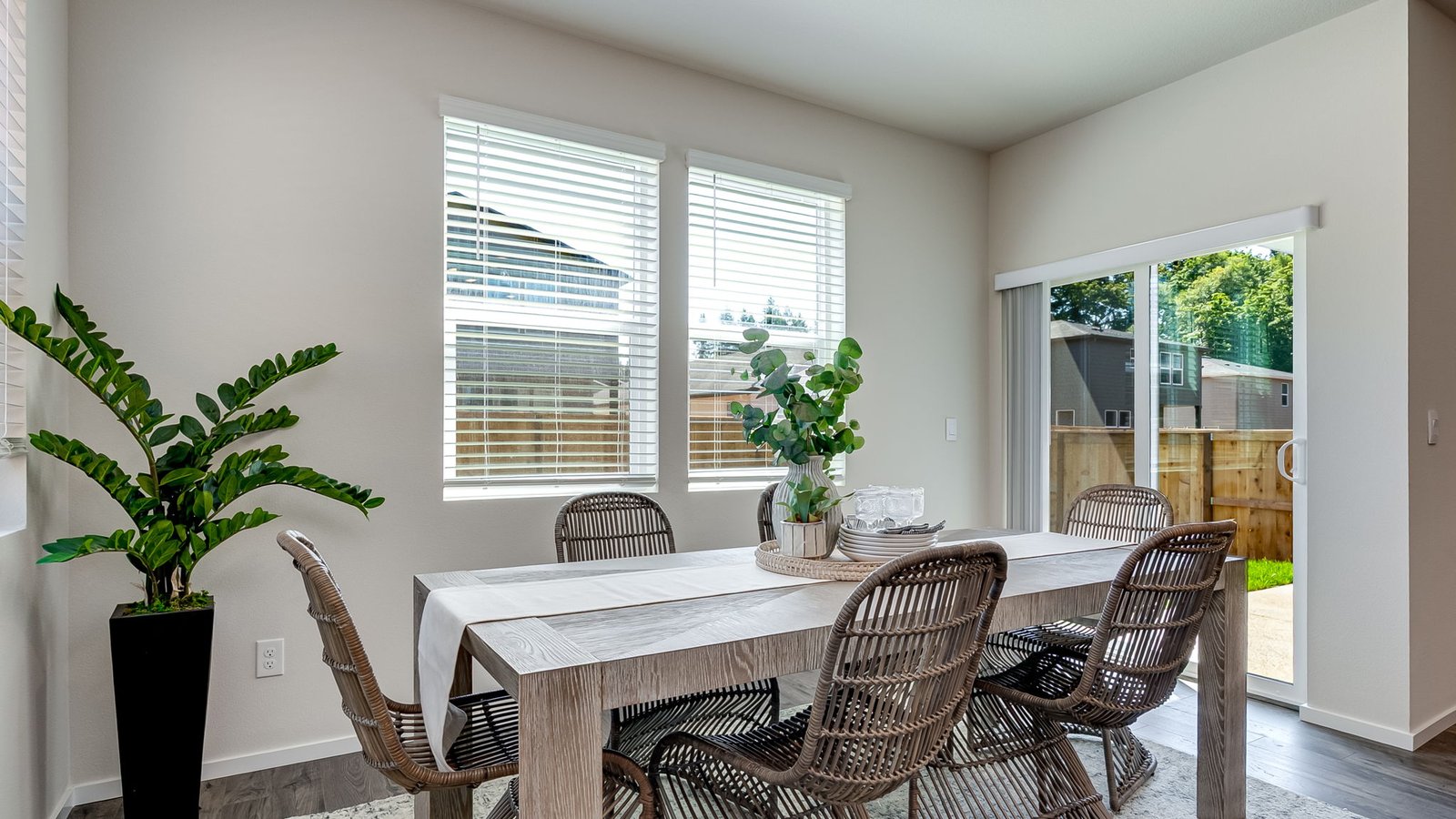 Dining area with a sliding glass door to a fenced backyard