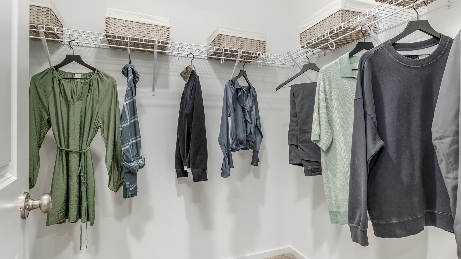 Primary bedroom walk-in closet with built-in shelves