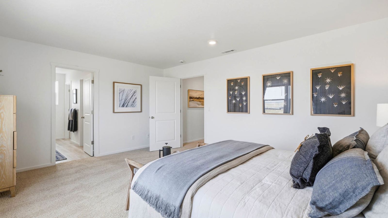 Primary bedroom with wall-to-wall carpet, a walk-in closet and an attached bathroom
