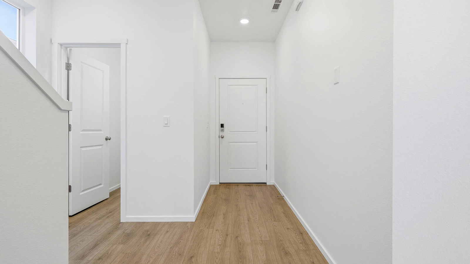 Entryway with a coat closet and laminate flooring