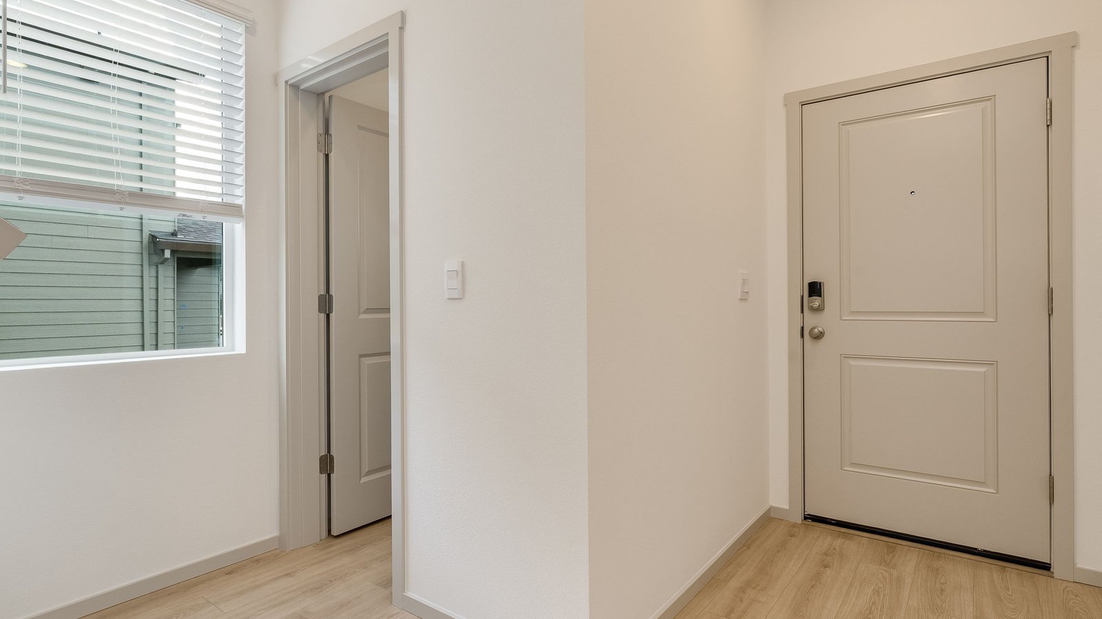 Entryway with a coat closet and laminate flooring