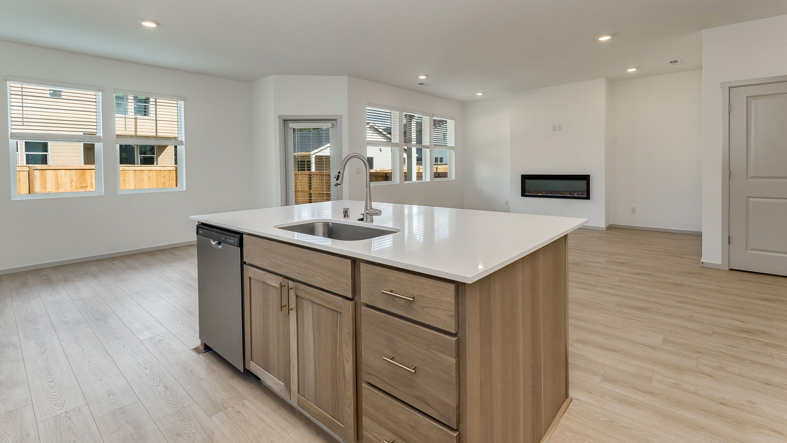 Kitchen with shaker cabinets, quartz counters, stainless steel appliances, pantry, and an island with a breakfast bar