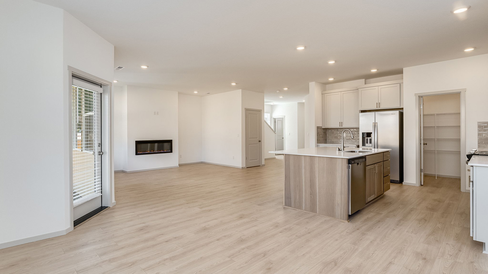 Great room with laminate flooring and an electric fireplace