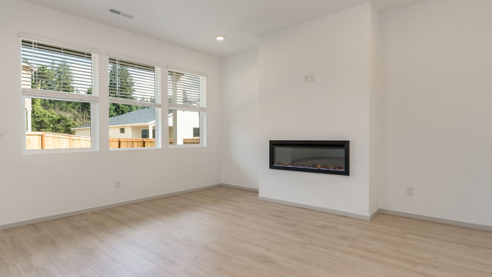 Great room with laminate flooring and an electric fireplace