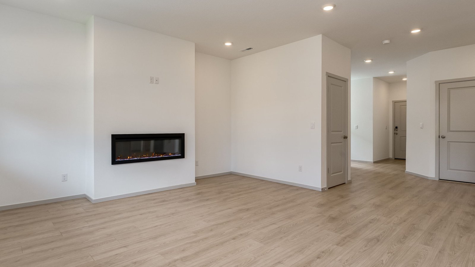 Great room with laminate flooring and an electric fireplace