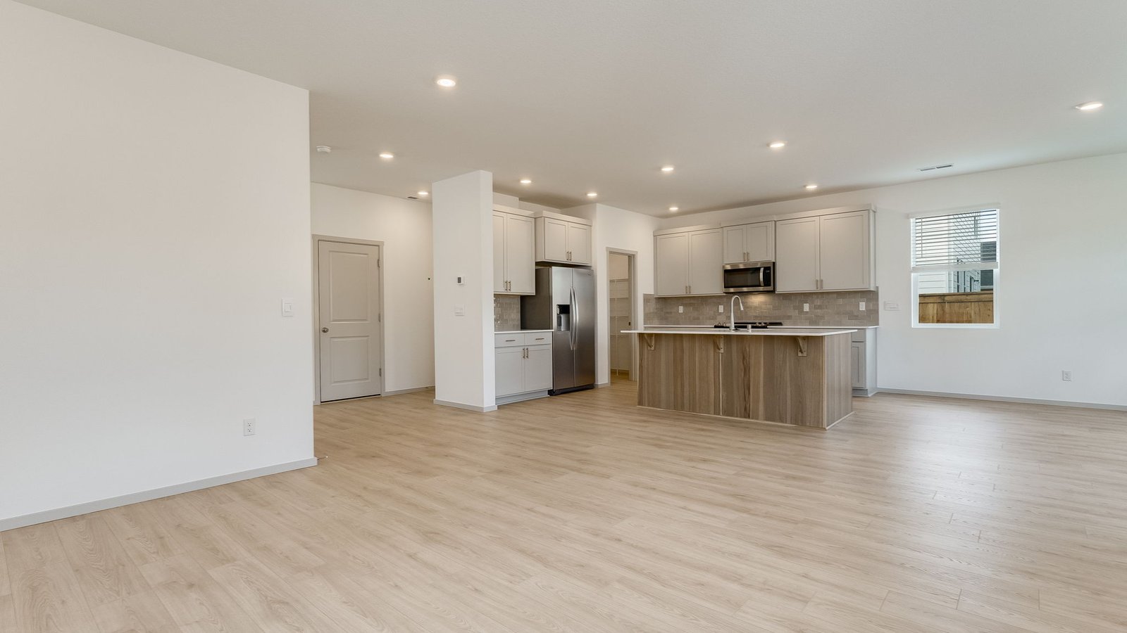 Great room with laminate flooring and an electric fireplace