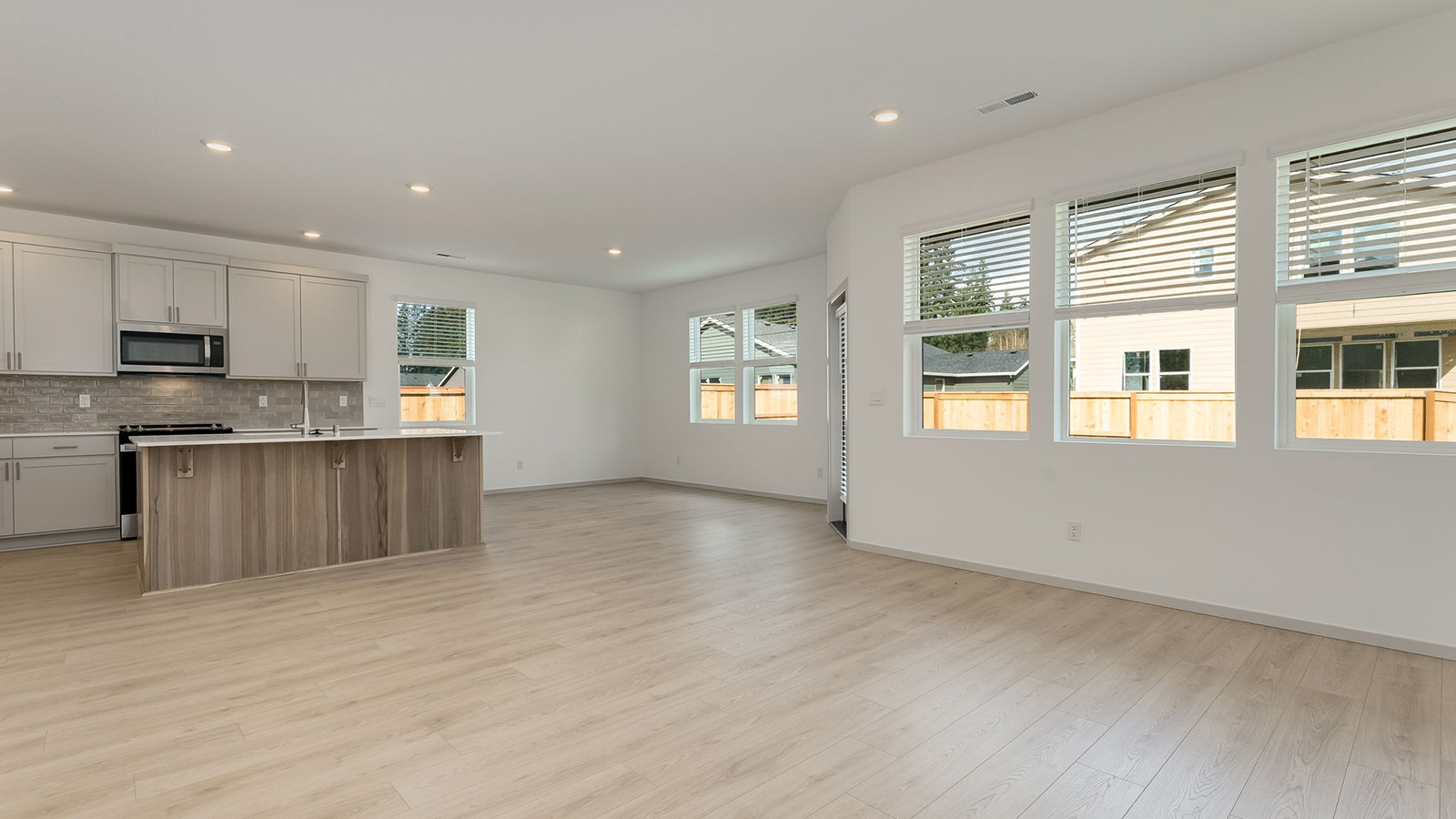 Great room with laminate flooring and an electric fireplace