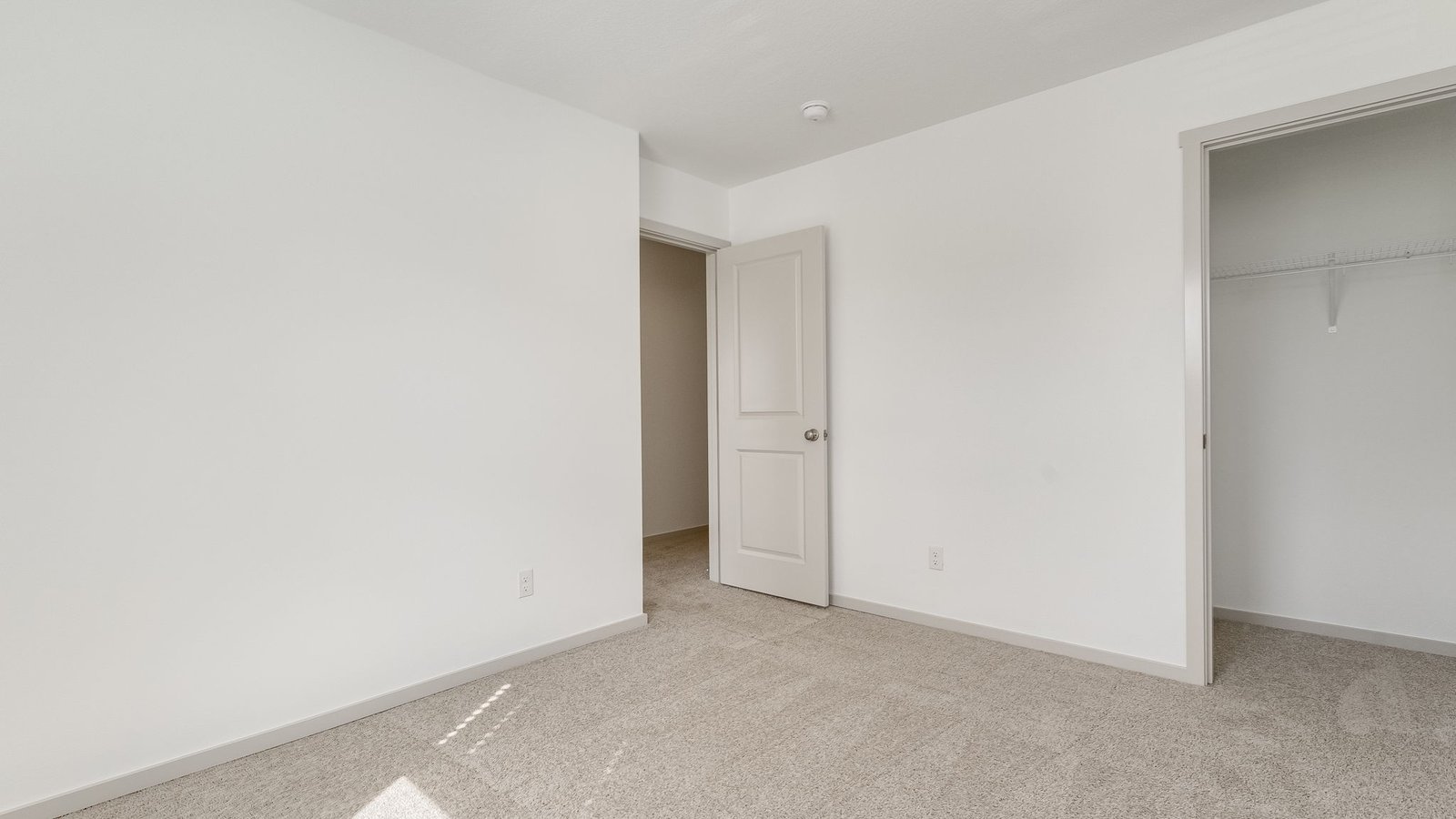 Bedroom with wall-to-wall carpet and a closet